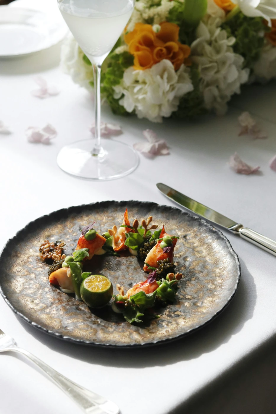 A plated lobster dish with herbs and citrus, illustrative stock photograph
